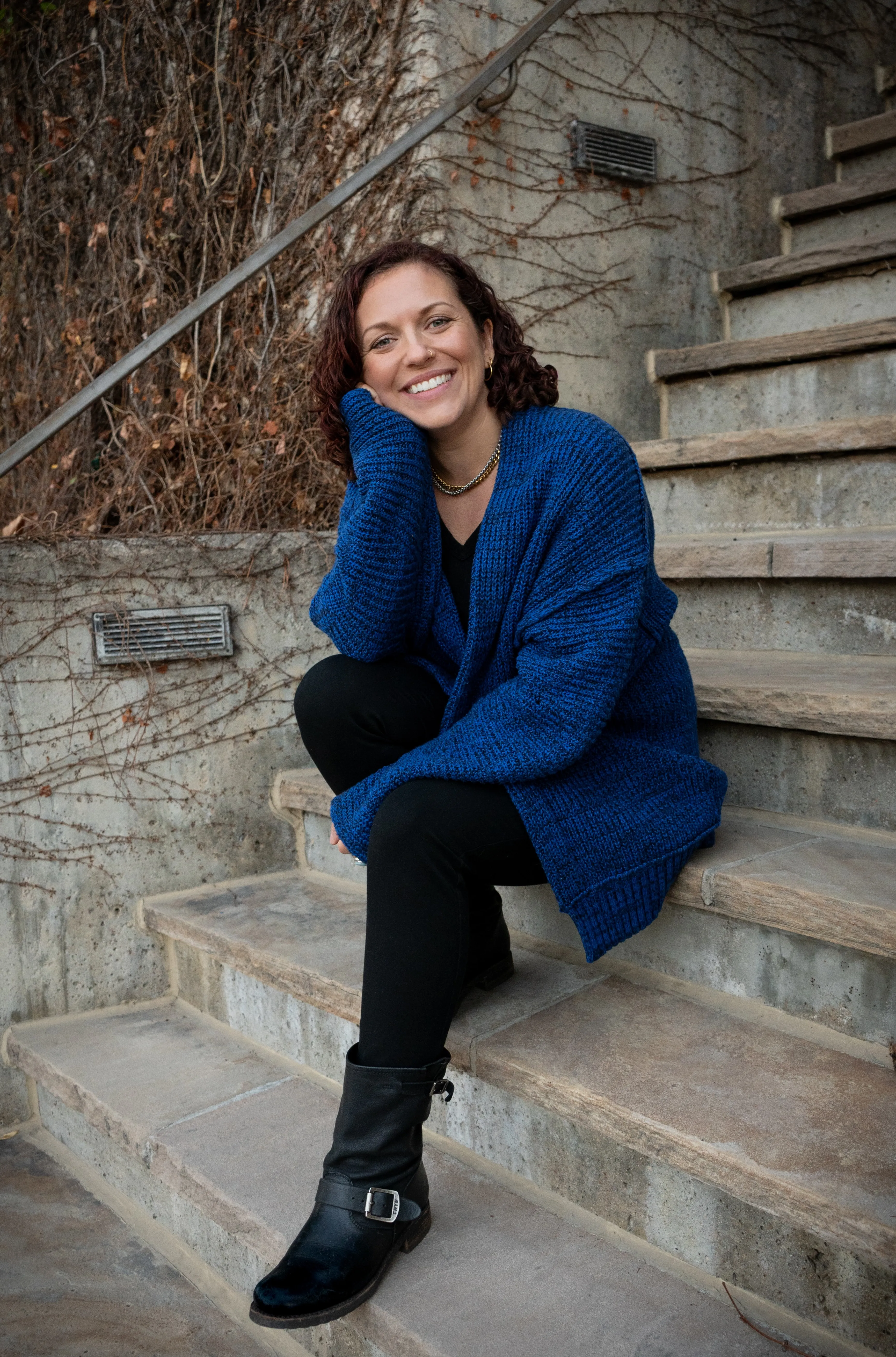 Photograph of Monique Vincent, therapist in Colorado, sitting on a staircase