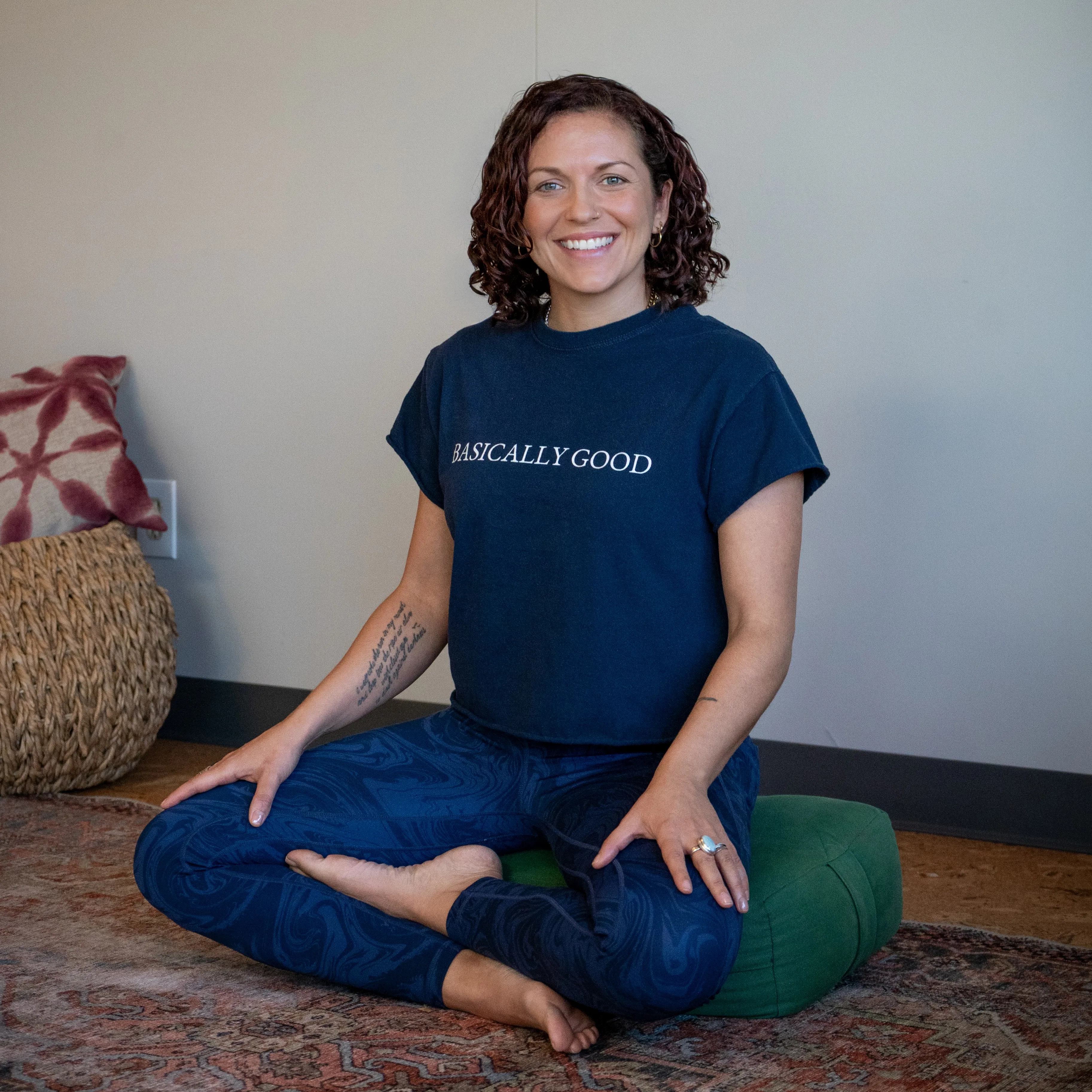 Monique Vincent sitting cross-legged and smiling